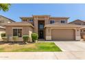 Charming two-story home featuring a well-manicured lawn and a two-car garage at 17419 W Elaine Dr, Goodyear, AZ 85338