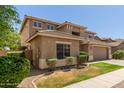 Charming two-story home featuring a well-manicured lawn and a two-car garage at 17419 W Elaine Dr, Goodyear, AZ 85338
