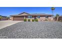 Charming single-story home with a brown tile roof, desert landscaping, and a two-car garage at 1911 N 42Nd Ave, Phoenix, AZ 85009