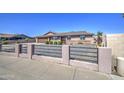 Single-story home with desert landscaping, fence with metal bars, and a brown tile roof at 1911 N 42Nd Ave, Phoenix, AZ 85009