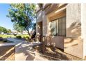 Exterior view of the condo with sidewalks, green space, and easy access to parking at 1941 S Pierpont Dr # 1037, Mesa, AZ 85206