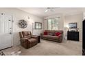 Inviting living room boasts neutral carpet, accent wall decor, and comfortable furnishings at 1941 S Pierpont Dr # 1037, Mesa, AZ 85206
