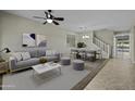 Bright living room with tile flooring, a ceiling fan and dining area that is great for gatherings at 1953 E Lafayette Ave, Gilbert, AZ 85298