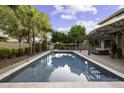Beautiful pool area with lounge seating, a pergola and mature trees, perfect for outdoor enjoyment at 1953 E Lafayette Ave, Gilbert, AZ 85298