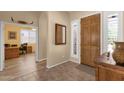 Foyer features decorative mirror, wood floors, front door with sidelight, and a hallway leading to the living spaces at 2069 E Winchester Way, Chandler, AZ 85286
