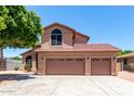 Charming home featuring a three-car garage, tiled roof, and low maintenance landscaping at 2213 N Ashbrook Cir, Mesa, AZ 85213