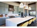 Modern kitchen with large island, stainless steel appliances, and stylish pendant lighting at 26885 N 104Th Pl, Scottsdale, AZ 85262