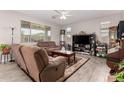 Cozy living room featuring tile floors, neutral paint, a ceiling fan, and comfortable seating at 40141 W James Ln, Maricopa, AZ 85138