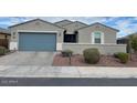 Charming single-story home with a well-maintained front yard and a two-car garage at 4040 E Caitlin Dr, San Tan Valley, AZ 85140