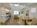 Bright and airy living space with an open layout, featuring a modern kitchen, dining area, and comfortable living room at 40927 W Sunland Dr, Maricopa, AZ 85138