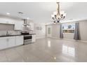 Bright, open kitchen seamlessly connects to a living area, offering ample counter space and modern stainless steel appliances at 4154 W Morten Ave, Phoenix, AZ 85051