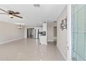 Open-concept living space showcasing tile floors, an inviting view into the kitchen, and ample natural light, promoting spacious living at 4154 W Morten Ave, Phoenix, AZ 85051