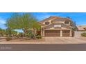Expansive two-story home with a three-car garage and meticulously maintained landscaping at 4402 E Barwick Dr, Cave Creek, AZ 85331