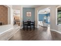 Bright dining area with modern lighting and an inviting open floor plan leading into the kitchen and living room at 4667 E County Down Dr, Chandler, AZ 85249