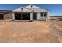 New home under construction features garage and window openings with scaffolding at 46868 W Coe St, Maricopa, AZ 85139