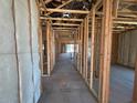 New construction interior featuring framed walls and utilities installed throughout the house at 46868 W Coe St, Maricopa, AZ 85139