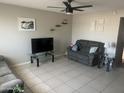 Spacious living room features a ceiling fan, neutral paint, and tile flooring at 5110 N 42Nd Dr, Phoenix, AZ 85019