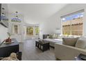 Bright living room featuring large windows, neutral colors, modern decor, and wood-look tile flooring at 5211 W Wikieup Ln, Glendale, AZ 85308
