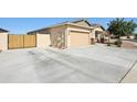 Long driveway leading to a two-car garage, complemented by a gated side yard, offers ample parking at 5724 N 108Th Ave, Phoenix, AZ 85037