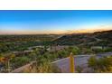 Picturesque view overlooking lush desert landscape with mountains in the distance at sunset at 6432 E El Sendero Rd, Carefree, AZ 85377