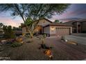 Charming home with desert landscaping, brick walkway, and a two-car garage at 6907 W Monona Dr, Glendale, AZ 85308