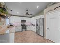 Spacious kitchen with stainless steel appliances and white cabinetry at 6907 W Monona Dr, Glendale, AZ 85308