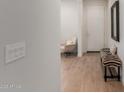 Bright entryway with wood-look tile flooring, a bench, and white front door at 7123 W Andrea Dr, Peoria, AZ 85383