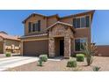 Two-story home with stone accents, a two-car garage, and xeriscaped front yard at 7123 W Andrea Dr, Peoria, AZ 85383