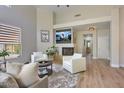 Bright living room boasts a fireplace, TV, and access to other parts of the house at 7128 E Bramble Berry Ln, Scottsdale, AZ 85266