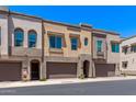 Modern townhomes with attached garages, neutral stucco, and arched entryways exude contemporary charm at 7492 E Via De Luna Dr, Scottsdale, AZ 85255