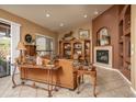 Inviting living room with a cozy fireplace and sliding glass doors at 8698 E Preserve Way, Scottsdale, AZ 85266