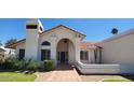 Inviting home exterior featuring a covered entryway and well-maintained garden at 9505 E Jenan Dr, Scottsdale, AZ 85260