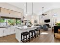 Open-concept kitchen features a large island with bar seating, modern appliances, and plenty of natural light at 9821 E Windrose Dr, Scottsdale, AZ 85260