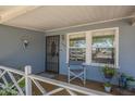 Charming front porch with a security door, desert decor, and a small seating area at 1003 E Mariposa St, Phoenix, AZ 85014