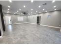 Spacious living room featuring recessed lighting, gray tile floors, and a large window providing natural light at 10637 N 16Th Ave, Phoenix, AZ 85029