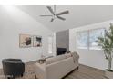 Inviting living room with a fireplace, sleek ceiling fan, and neutral color palette at 1075 E Chandler Blvd # 212, Chandler, AZ 85225