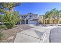 Two-story home with a well-manicured front yard and a blue front door at 1107 E La Salle St, Phoenix, AZ 85040
