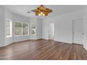 Bright bedroom with hardwood floors, a ceiling fan, and large windows overlooking the backyard at 11630 W Jefferson St, Avondale, AZ 85323