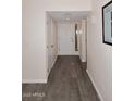 Entry way featuring laminate flooring, a coat closet, and white walls with white trim at 12830 S Wakial S Loop, Phoenix, AZ 85044