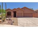 Charming single-story home with a two-car garage and desert landscaping at 14657 N 103Rd Way, Scottsdale, AZ 85255
