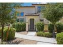 Inviting front entry with landscaped walkway leading to the arched doorway and iron gate at 14870 W Encanto Blvd # 1091, Goodyear, AZ 85395