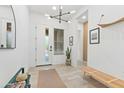 Bright entryway with modern lighting, tiled floors, and stylish decor with a bench for seating at 1492 W Bruce Ave, Gilbert, AZ 85233