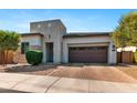 Inviting exterior featuring desert landscaping, a modern design and a two-car garage for easy parking at 1492 W Bruce Ave, Gilbert, AZ 85233