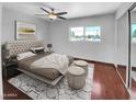 Staged main bedroom with a tufted headboard, a light colored rug, and ample natural light at 1750 E Mateo Cir # 103, Mesa, AZ 85204