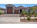 Inviting home with a three-car garage, desert landscaping, and a welcoming entrance at 17597 W Red Fox Rd, Surprise, AZ 85387