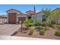 Beautiful single-story home boasting desert landscaping and a three-car garage at 17597 W Red Fox Rd, Surprise, AZ 85387