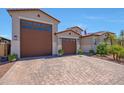 Charming home with a spacious three-car garage and a beautifully paved driveway at 17597 W Red Fox Rd, Surprise, AZ 85387