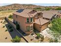 A lovely two-story home, in a quiet suburb, with red tiled roof and owned solar panels on the roof at 18132 W Cardinal Dr, Goodyear, AZ 85338