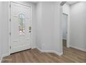 Bright, spacious foyer features a white decorative door with glass detail and clean, neutral walls at 18132 W Cardinal Dr, Goodyear, AZ 85338