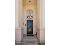 Elegant front door with decorative ironwork, a stylish chandelier, and a welcoming entrance at 1953 W Lark Dr, Chandler, AZ 85286
